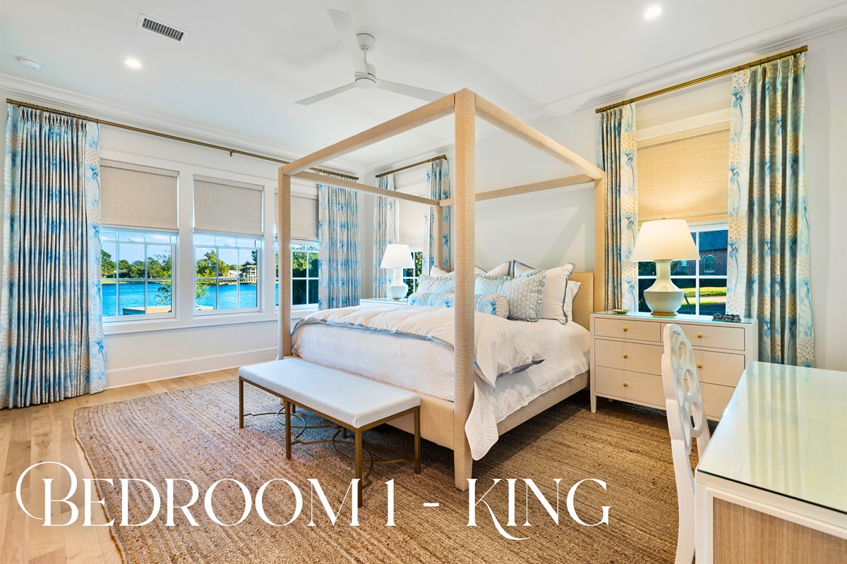 Primary suite with large windows and natural textures.