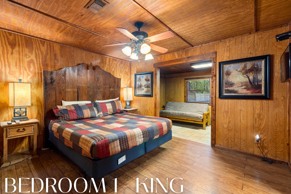 Comfy king bed with warm cabin character.