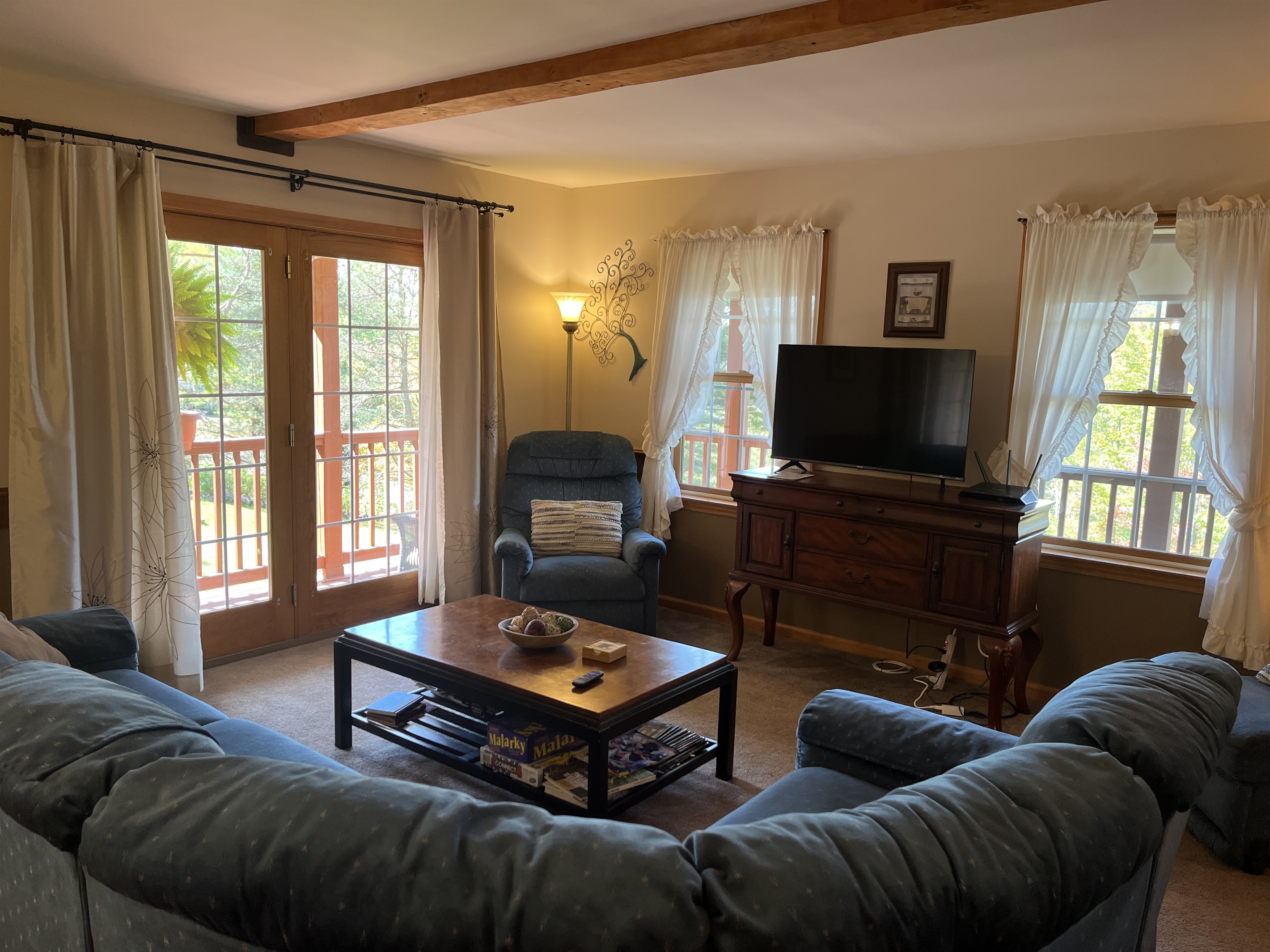Living room with sliders on to wraparound porch
