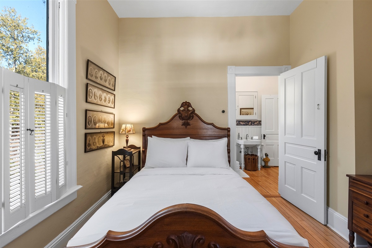 Queen bedroom on main floor w/ warm tones & natural light