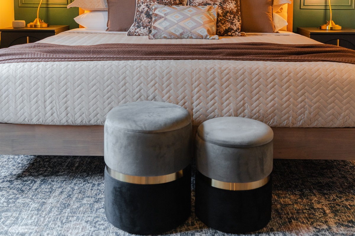 A spacious bedroom with a king bed and a comfortable setup for a good night’s sleep.