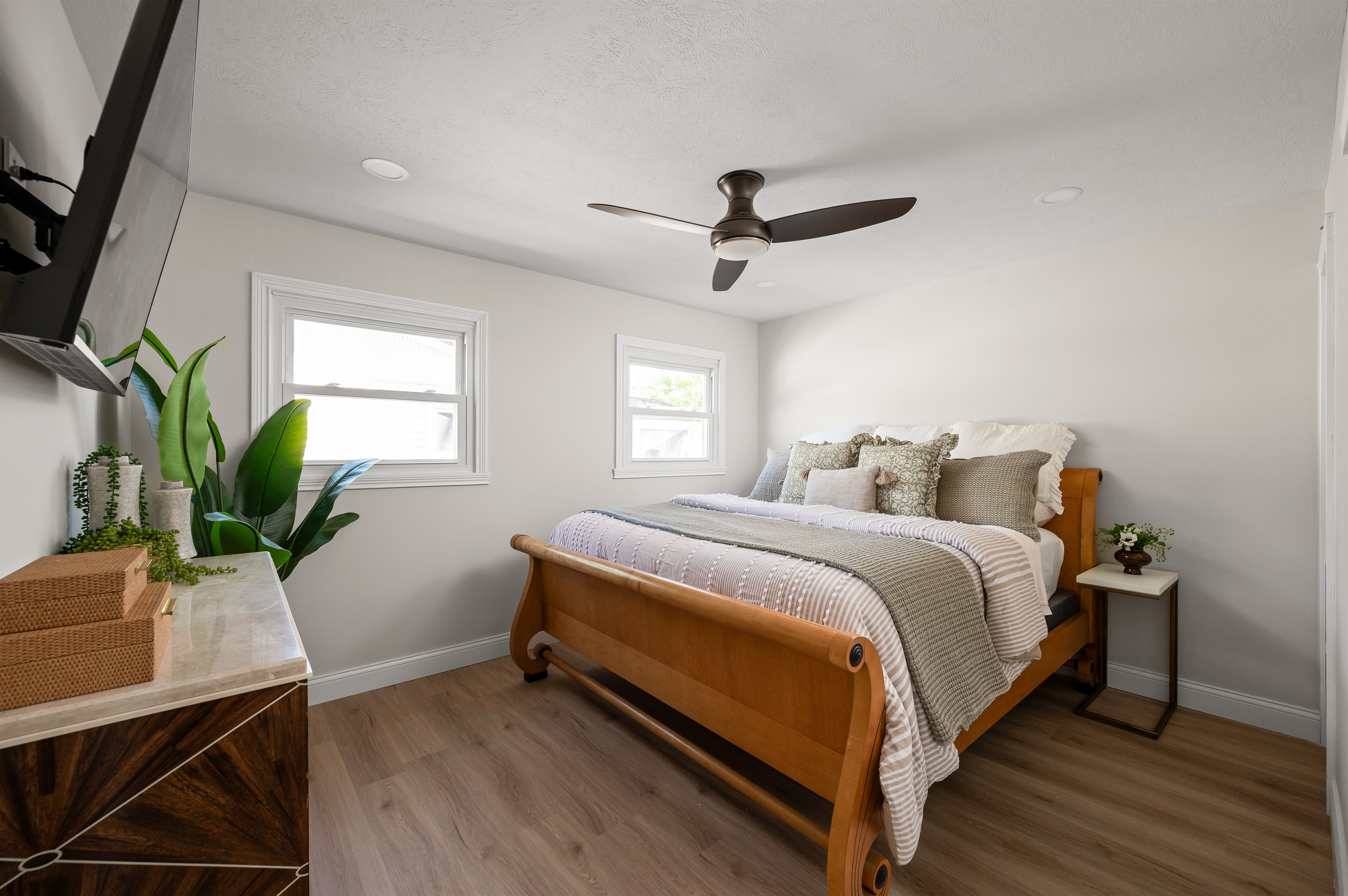 Relax in the spacious primary bedroom featuring a comfortable king size bed designed for a restful night’s sleep after a day exploring Indy.