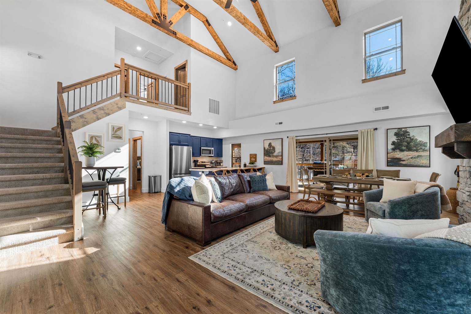 Walk in to the open-concept living space with vaulted ceilings, awesome wood beams and plenty of room to gather and relax.