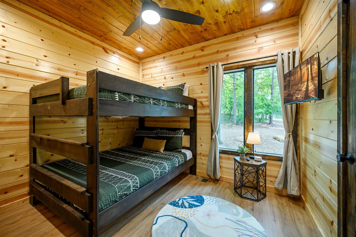 Kid-friendly fun with cozy beds and a woodland view.