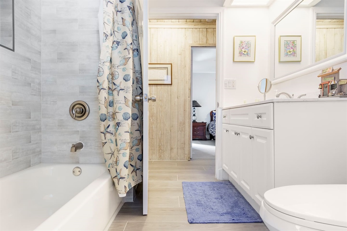 Full-bathroom #2  wide door way, is located off the “Florida Room” and is central to the Pool and patio as well as living/dining area. Large well-lit mirror and vanity. Bathtub with grab bars and Closet where beach & pool towels are stored.