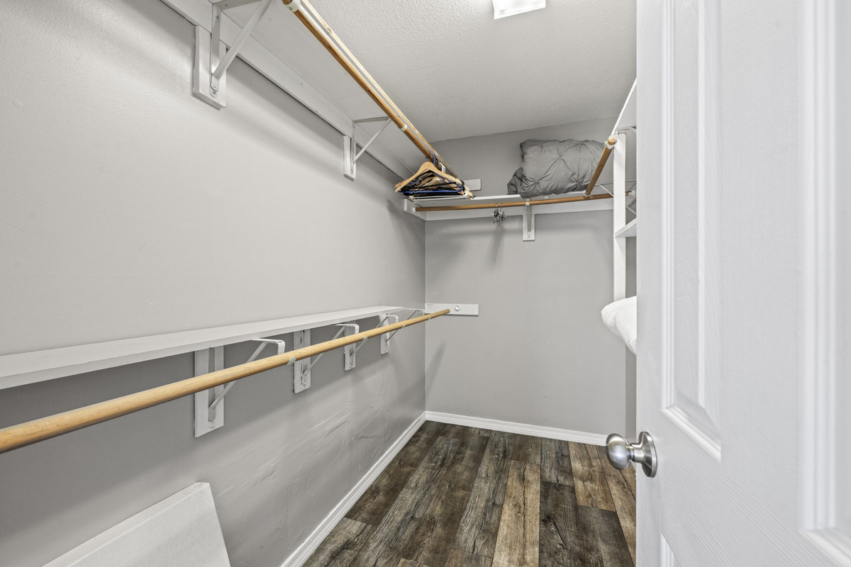A generous walk-in closet with ample shelving and hanging space to unpack and settle in for your stay.