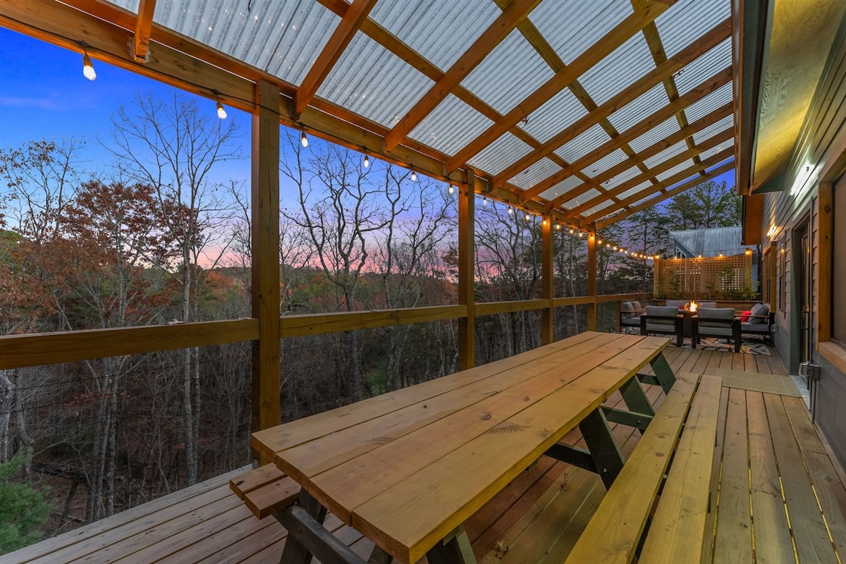 Dine under the twilight sky at the large outdoor table—perfect for enjoying sunset views and memorable meals.