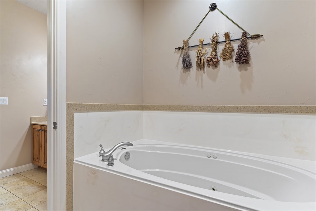 Spa-inspired primary bathroom featuring a luxurious jetted soaking tub—perfect for unwinding after a day of adventure.