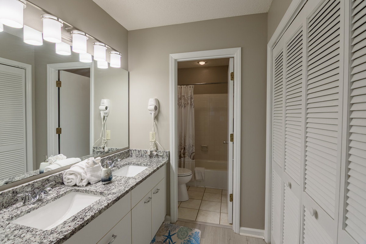 Main bathroom with double sinks and tub/shower combo