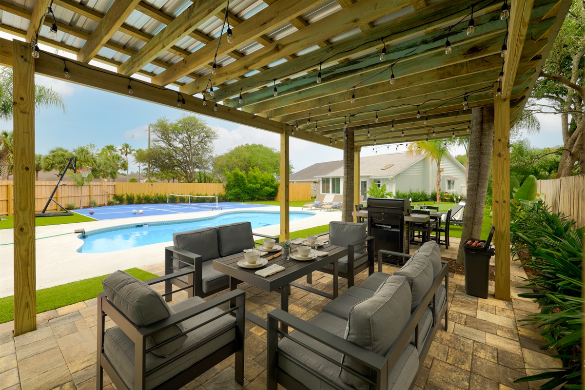 Covered outdoor dining tables with pool views