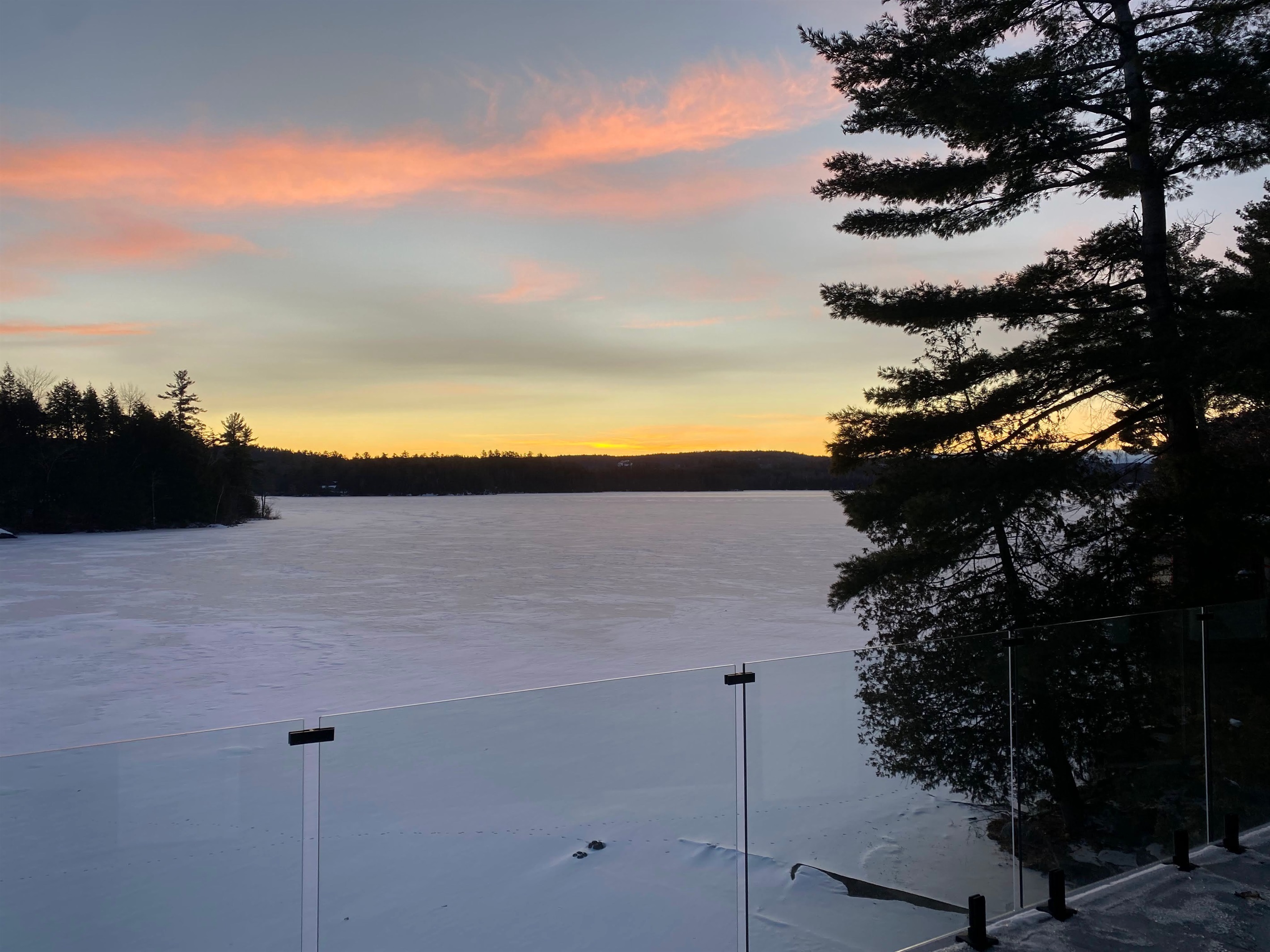 View of sunset across Lac McGregor from cottage lower balcony