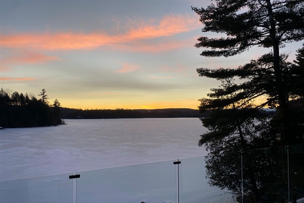 View of sunset across Lac McGregor from cottage lower balcony