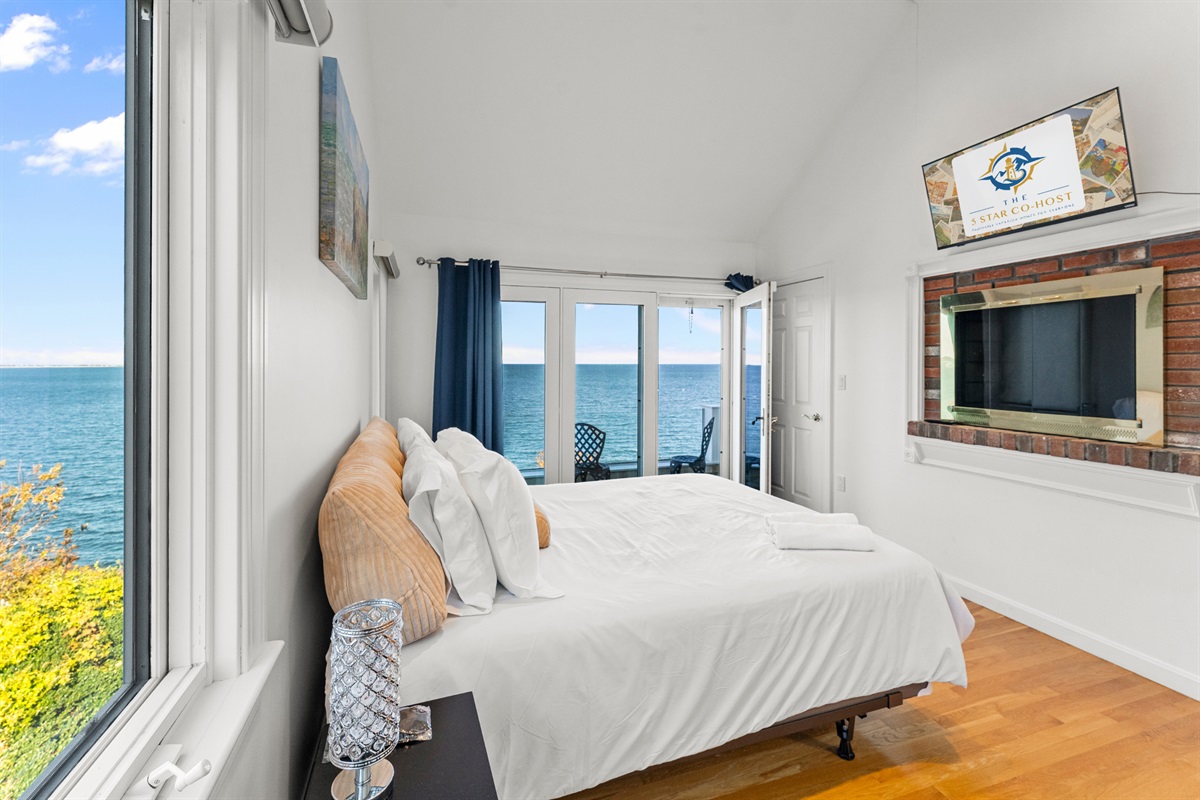 Second-level bedroom featuring a queen bed and serene ocean vistas.