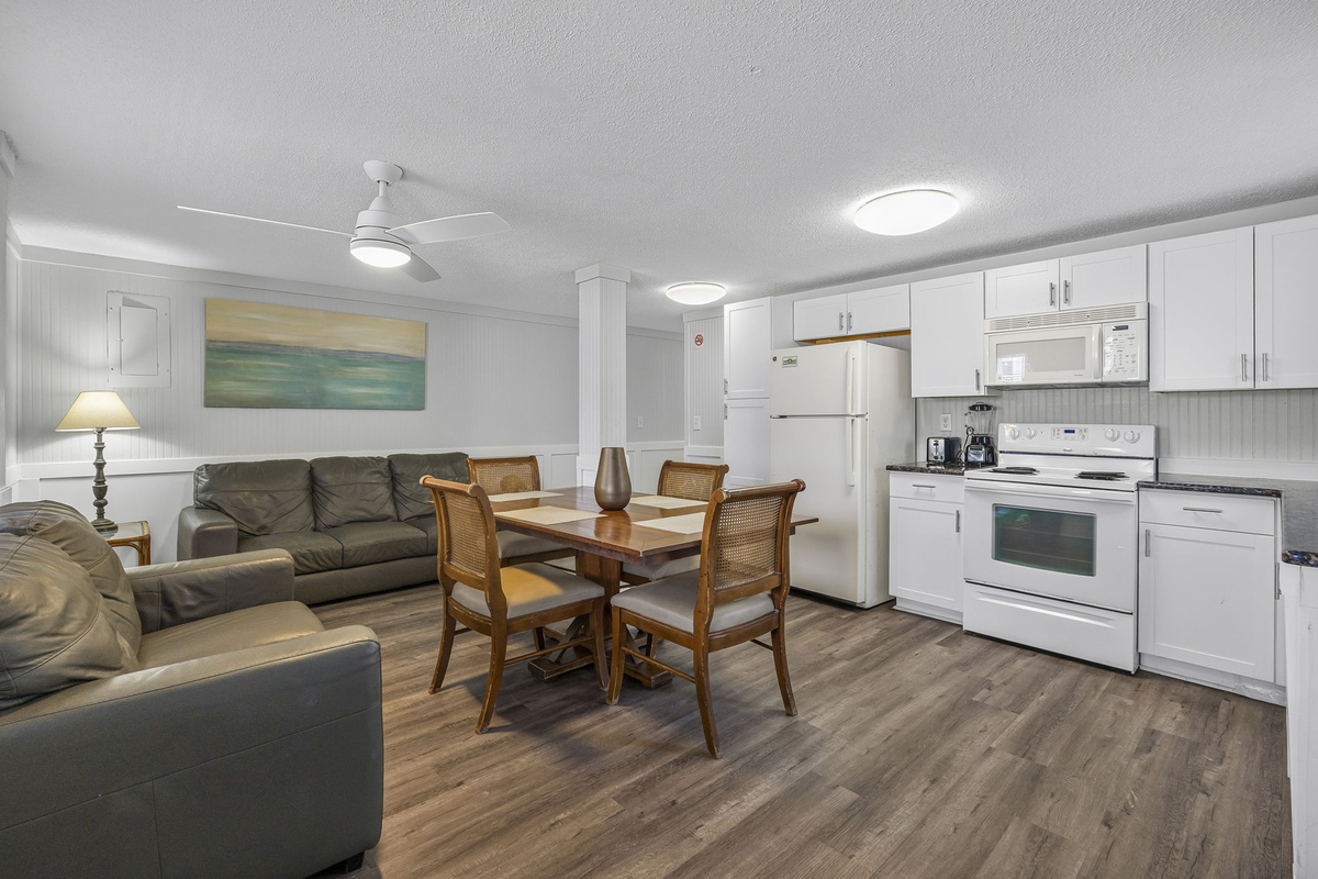 Full kitchen in Unit 2 with Dining room table and Smart TV