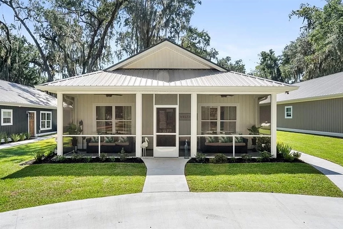 The circle drive is in front of the exterior of the home.