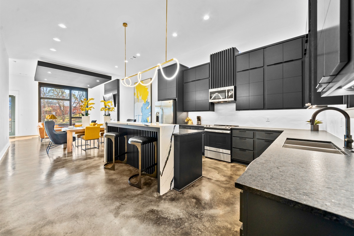 The open kitchen design balances function and style with modern appliances, sleek finishes, and plenty of room for cooking or entertaining.
