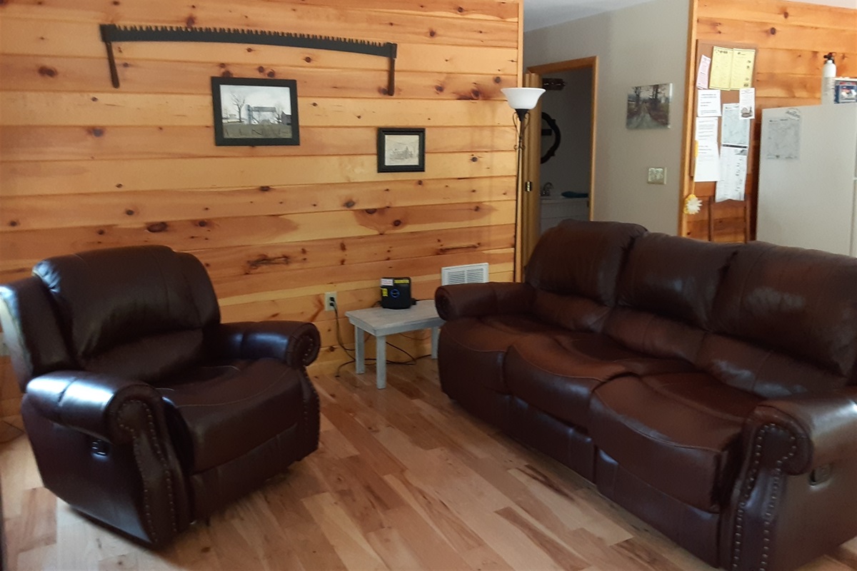 The living room is warm and inviting, with a cozy, rustic feel that makes it easy to relax after a day in the mountains.