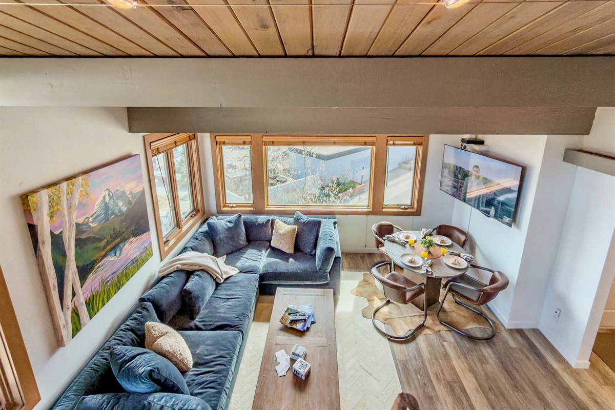 Climb up to the loft for a fantastic vantage point - the whole condo spread out below you, views out the window & the fireplace glowing. The kids would consider this a cool spot to sprawl out, with popcorn, for the family-friendly featured movie.   