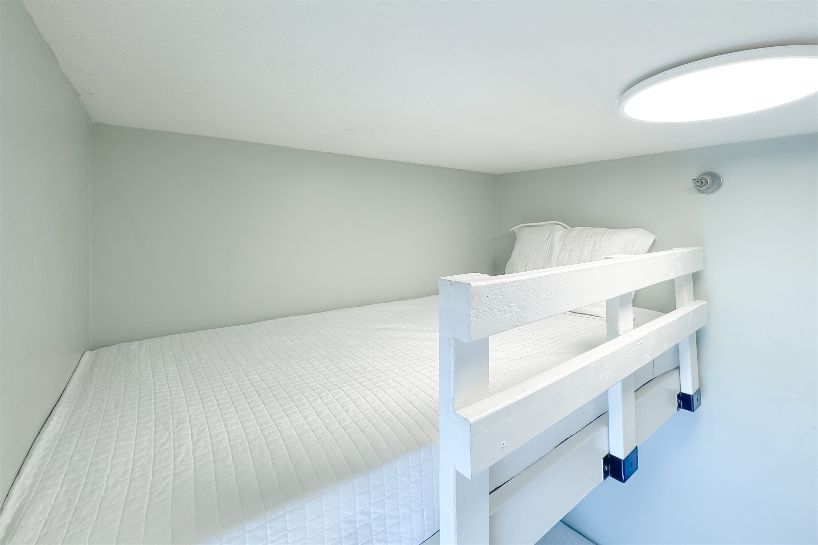 Versatile bunk bedroom offering comfortable accommodations for guests or family. This space maximizes functionality and style, providing a cozy and inviting atmosphere.