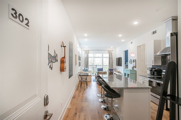 The view from the entry way. Kitchen, Living space and balcony