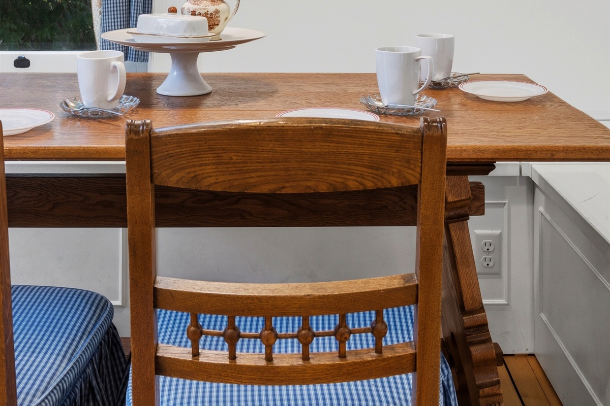 Cozy breakfast nook w/ wooden table & simple seating