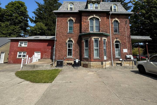 Exterior photo of the building, your space will be located in the add-on to the left of our charming centennial home 