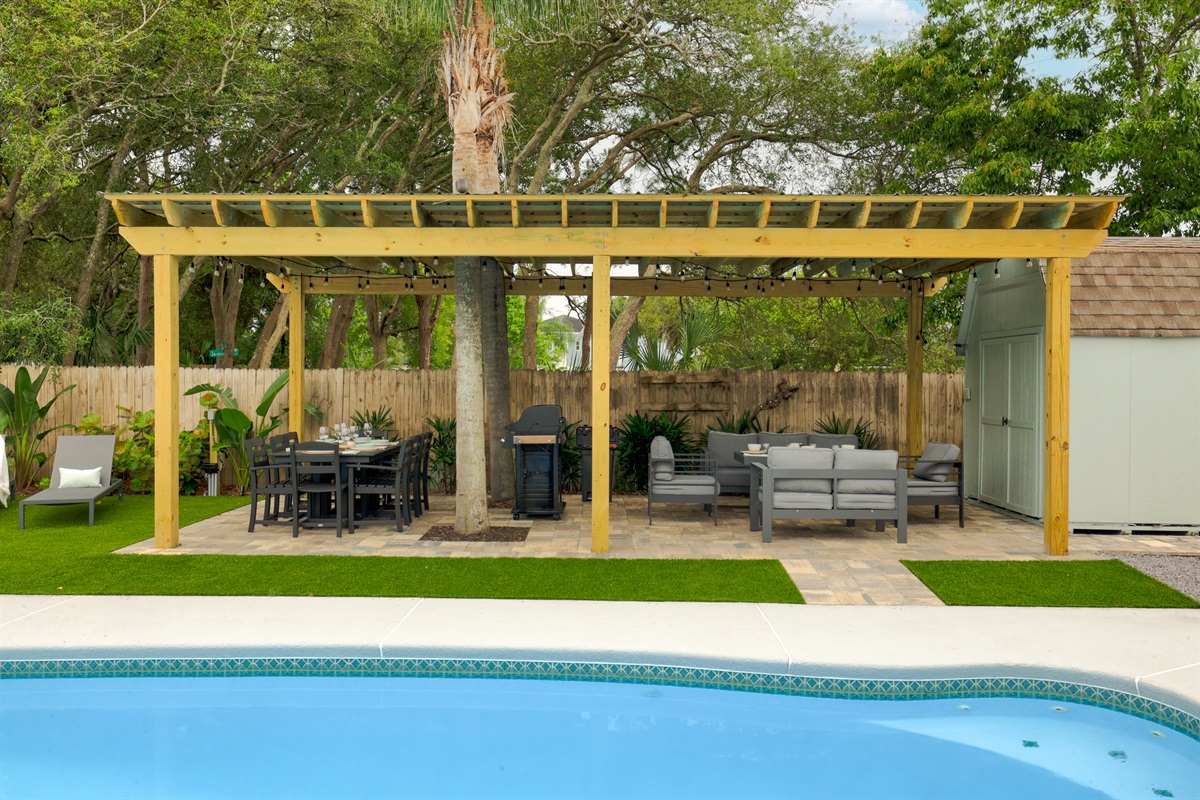 Pergola lounge with outdoor seating steps from the pool