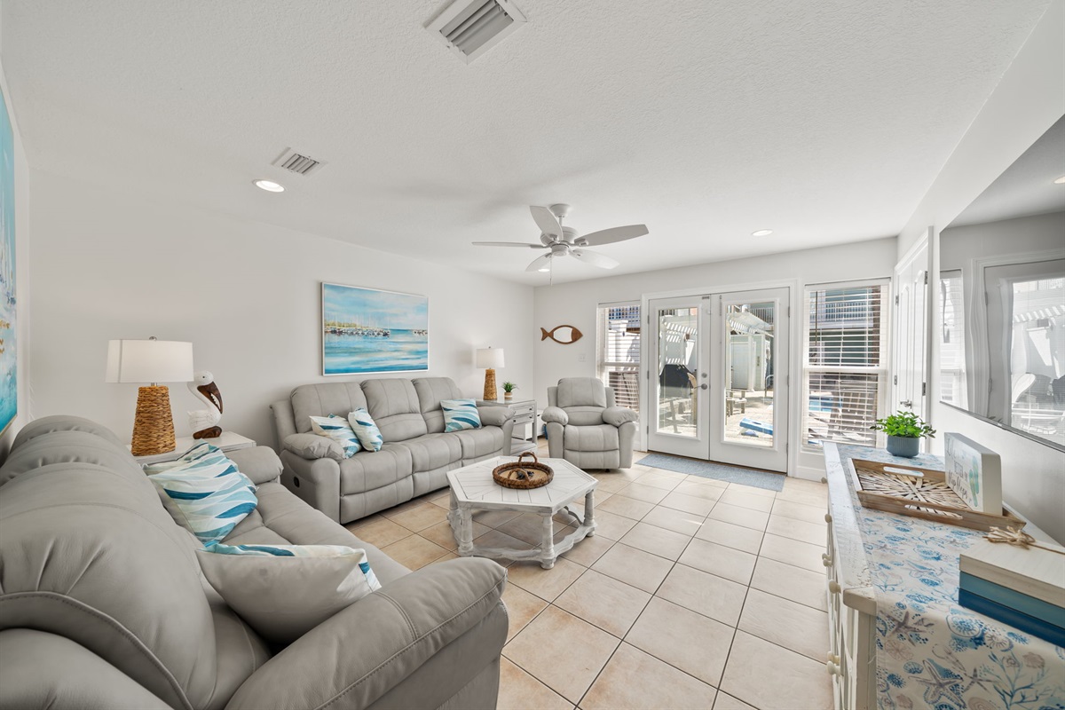 Two leather couches, that have 4 recliners in them, plus a large rocking recliner for ample seating! This living room overlooks the pool which is right outside the door!