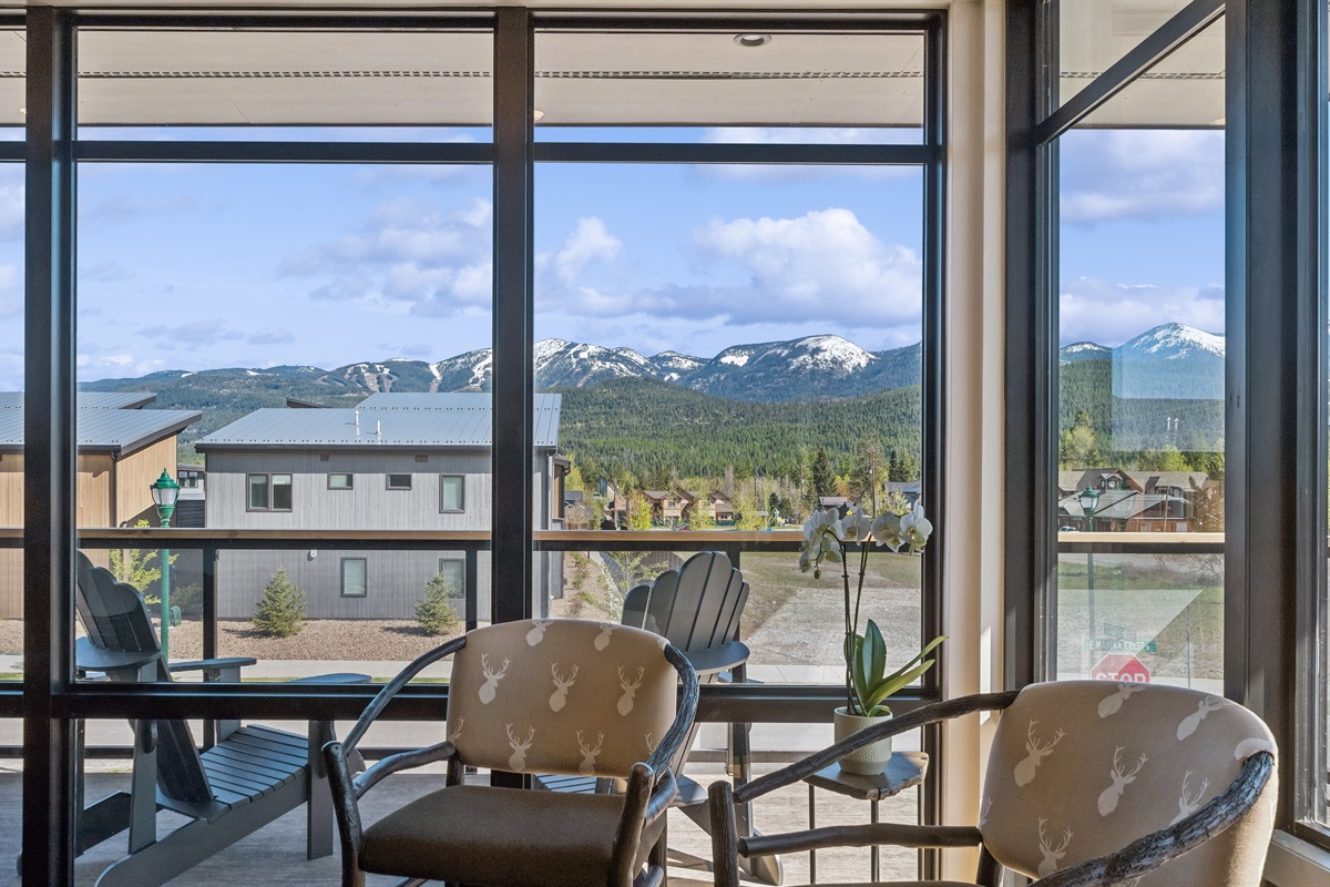 Dramatic mountain views through floor-to-ceiling windows invite relaxation and adventure!