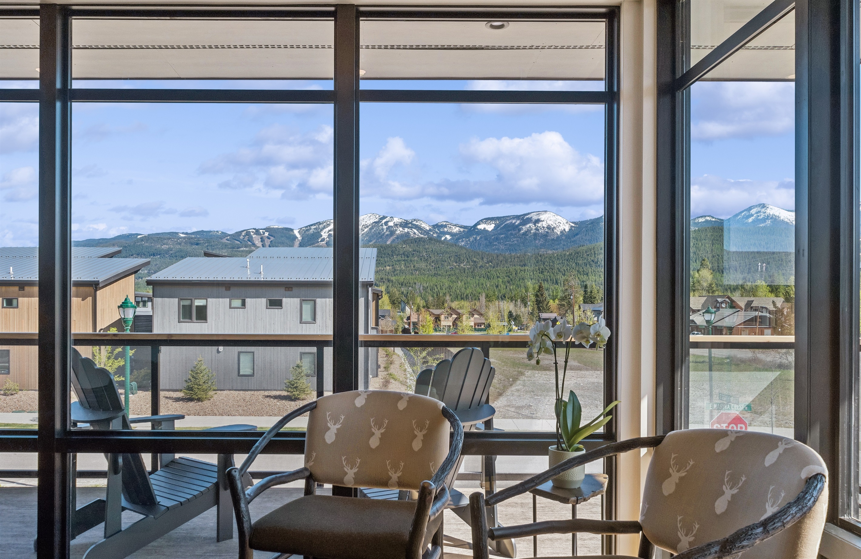 Dramatic mountain views through floor-to-ceiling windows invite relaxation and adventure!