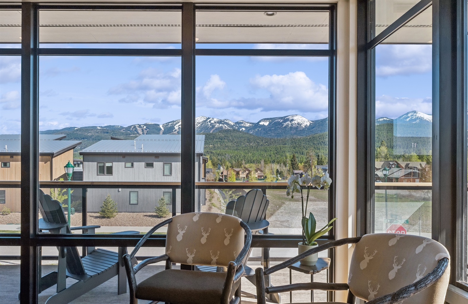 Dramatic mountain views through floor-to-ceiling windows invite relaxation and adventure!