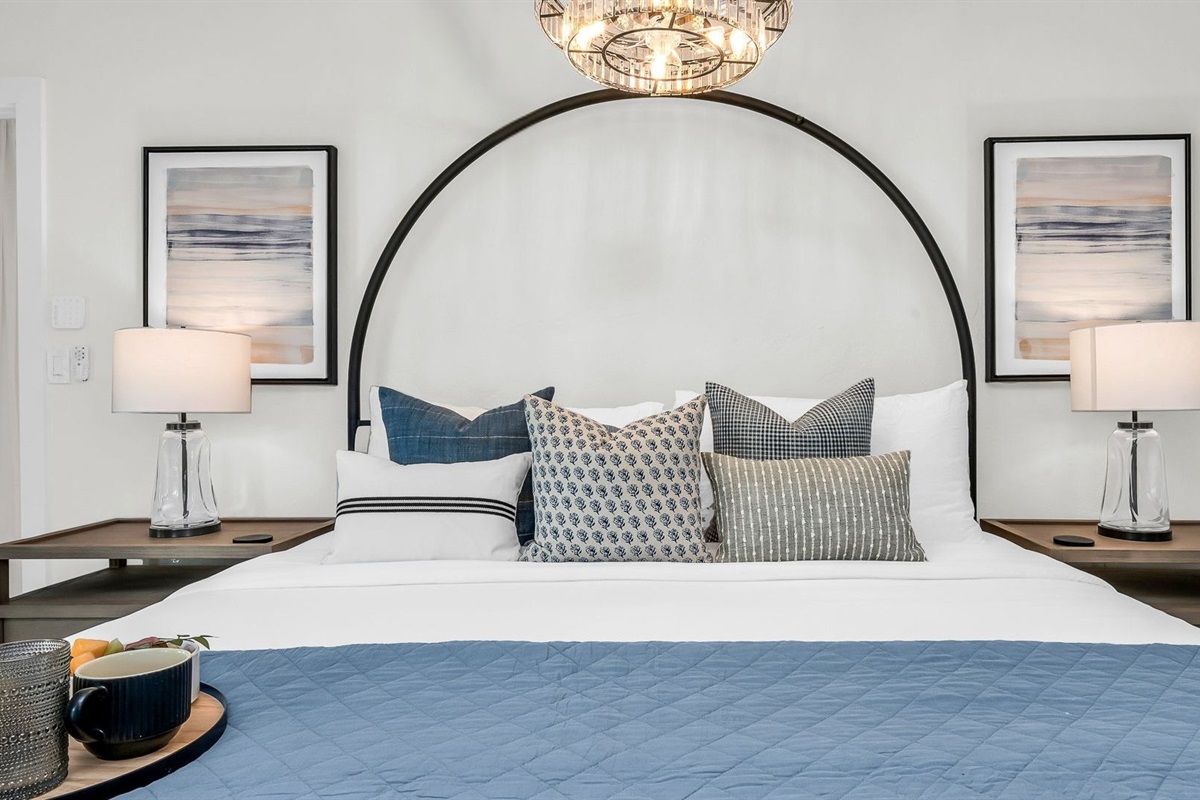 This second primary suite offers a plush king bed, private ensuite bathroom, and walk-in closet for added comfort. Enjoy poolside views and direct access to the outdoor living area, making it the perfect blend of luxury and convenience.