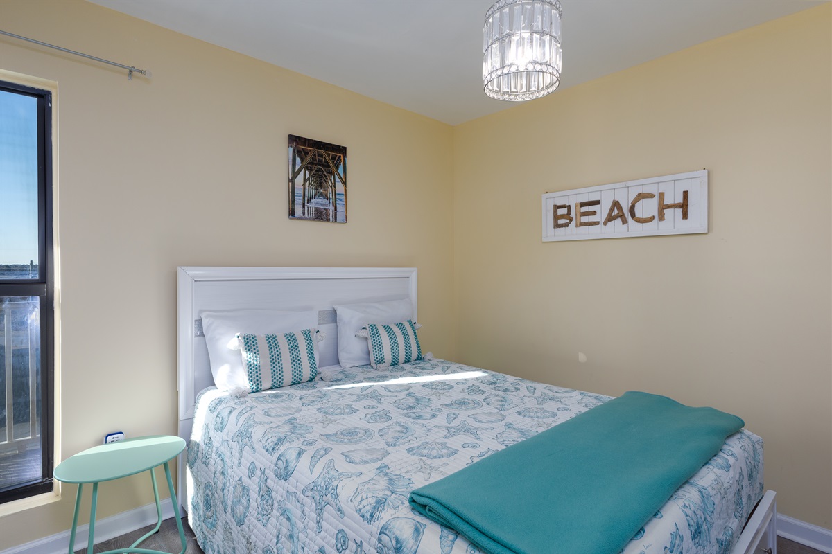 Coastal-themed bedroom with view