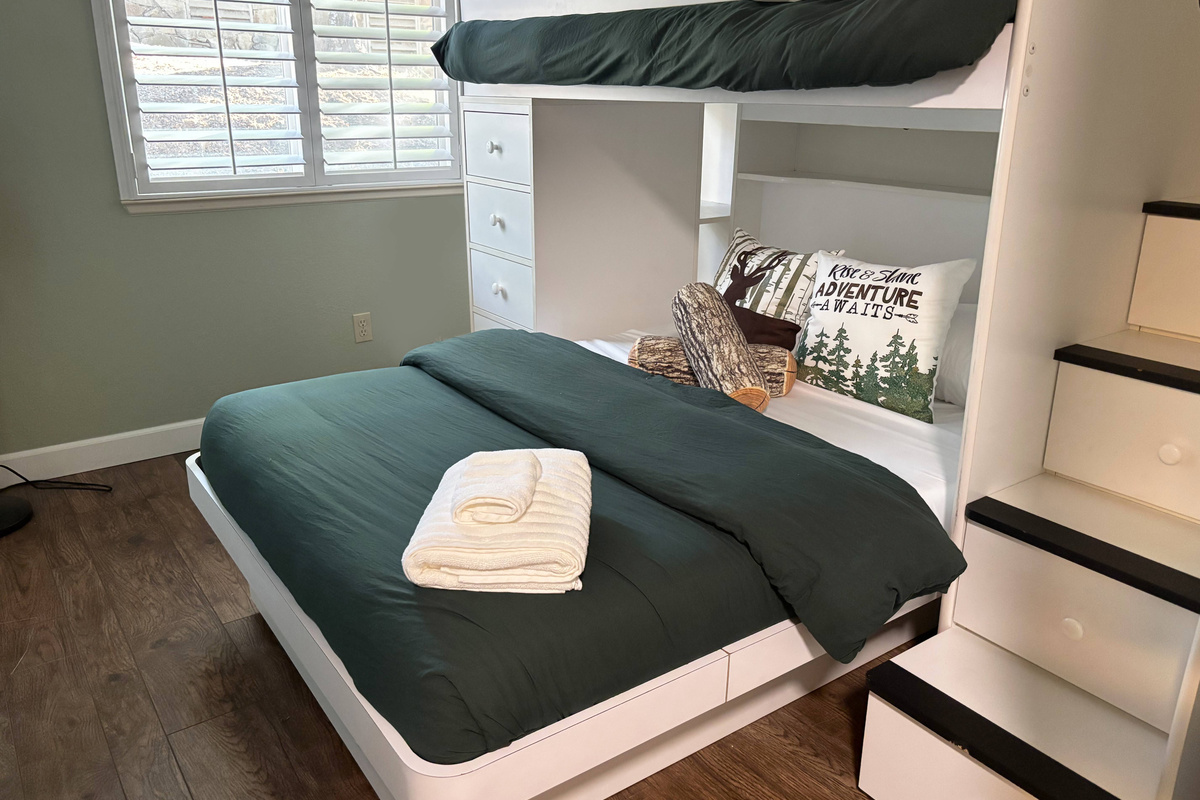 If you're staying with children, they will love this bunk room! With a queen-size bed and a single bed on top of the stairs, it's perfect for three guests. 