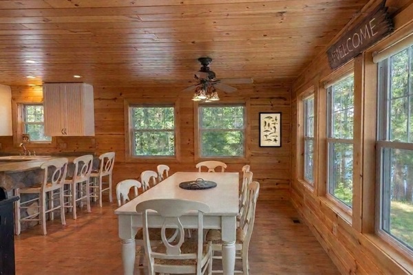 Gather for meals or game nights around the large table with stunning lake views beyond the windows. Spacious, with plenty of room for all!
