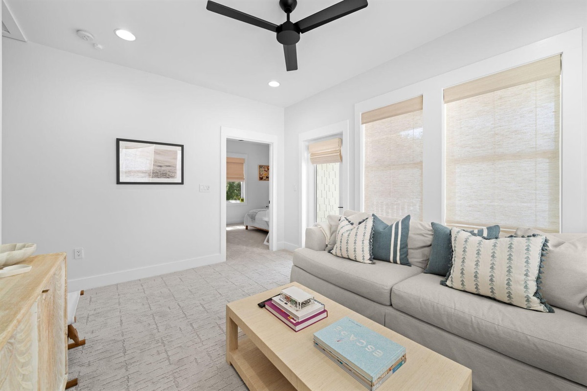 The upstairs living room has access to the front porch.