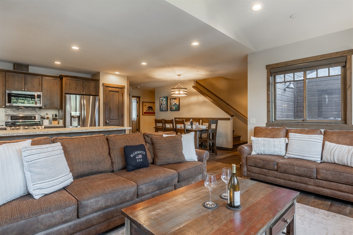 The open-concept layout at Triple Black keeps everyone together — relax by the fire while meals and conversations flow easily between kitchen and dining.