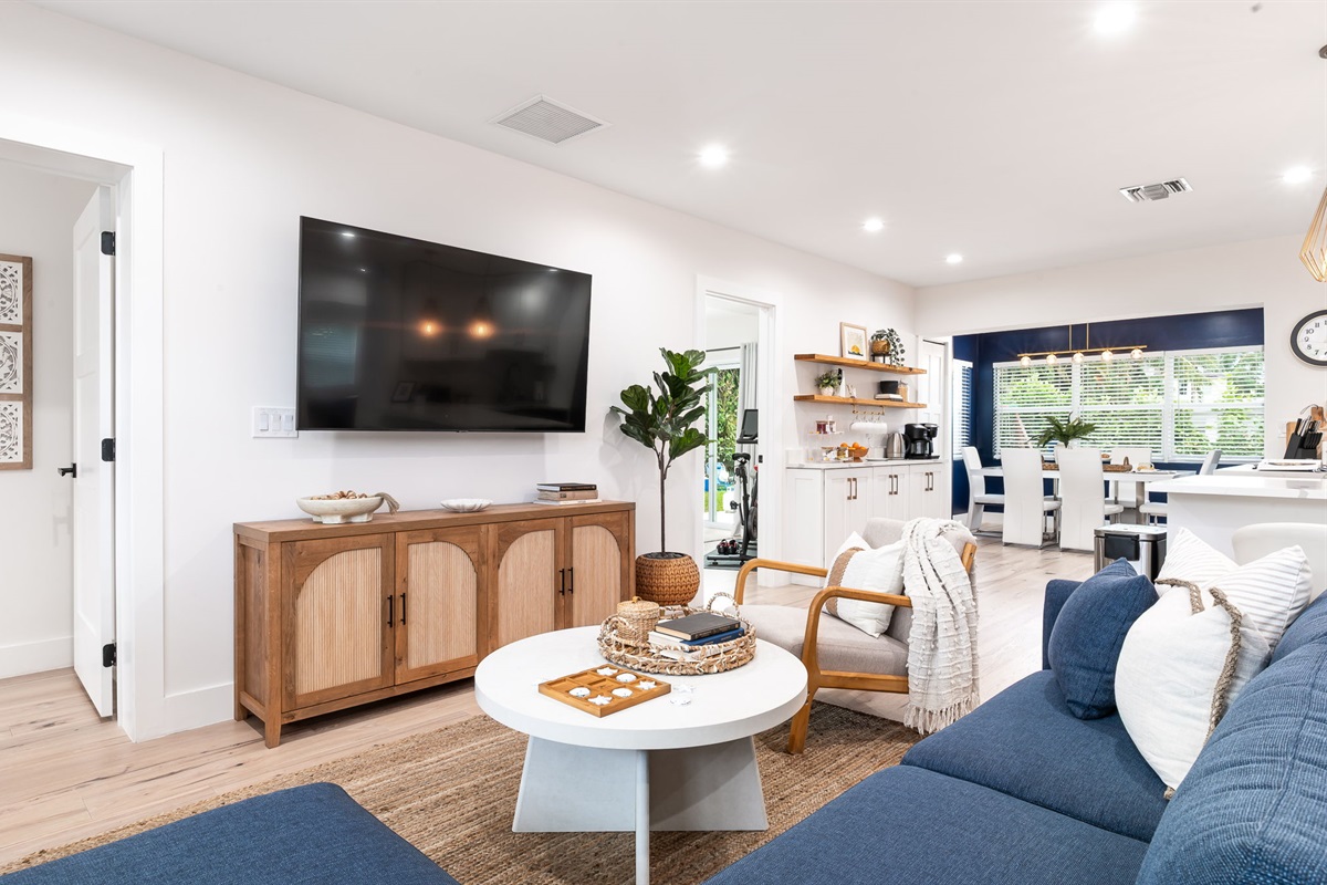 Spacious living room with smart TV and cozy seating for movie nights or group hangouts.