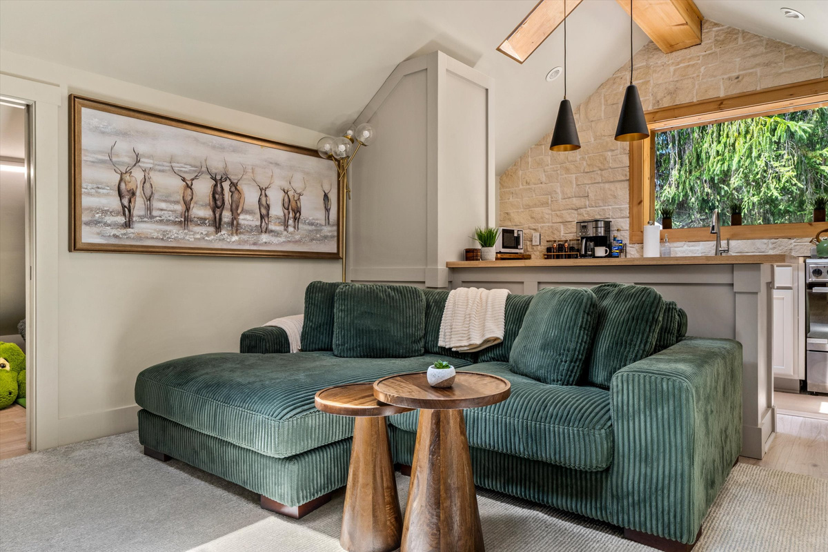 The Penthouse: Cozy Living Room with 55-inch Smart TV, Fireplace, and bistro table.
