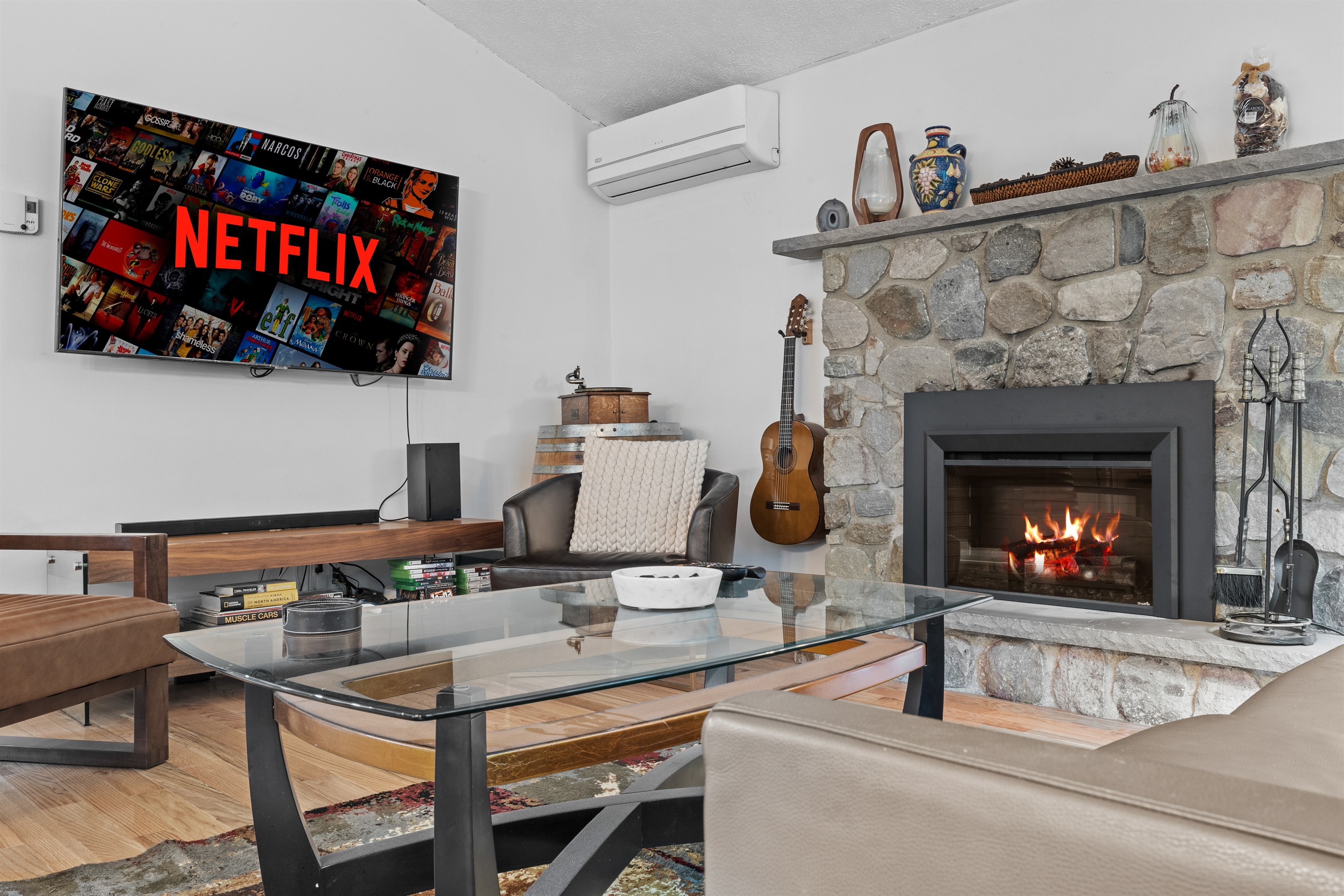 Cozy living room with large TV, electric fireplace, and plush seating—perfect for movie nights