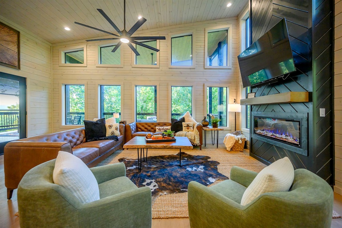 Huge living room featuring vaulted ceilings with an elevated decor package.  Real leather couches and two swivel chairs provide ample seating for all guests.