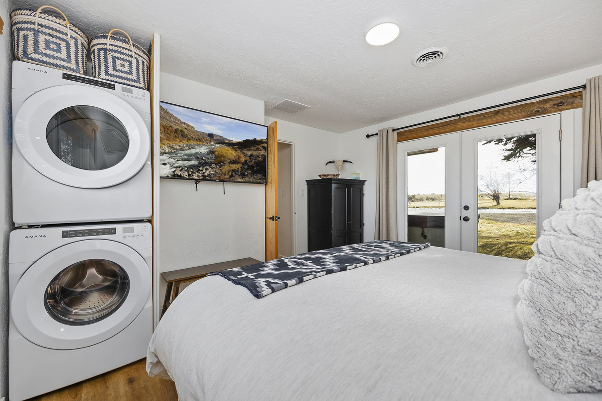 King bedroom with an in-room stacked washer and dryer for easy longer stays