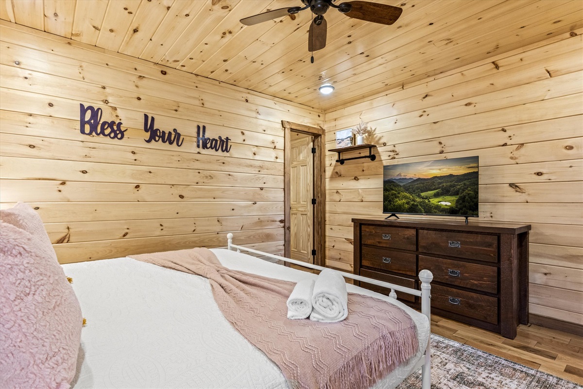 The "Bless Your Heart" bedroom has a Smart TV and dresser