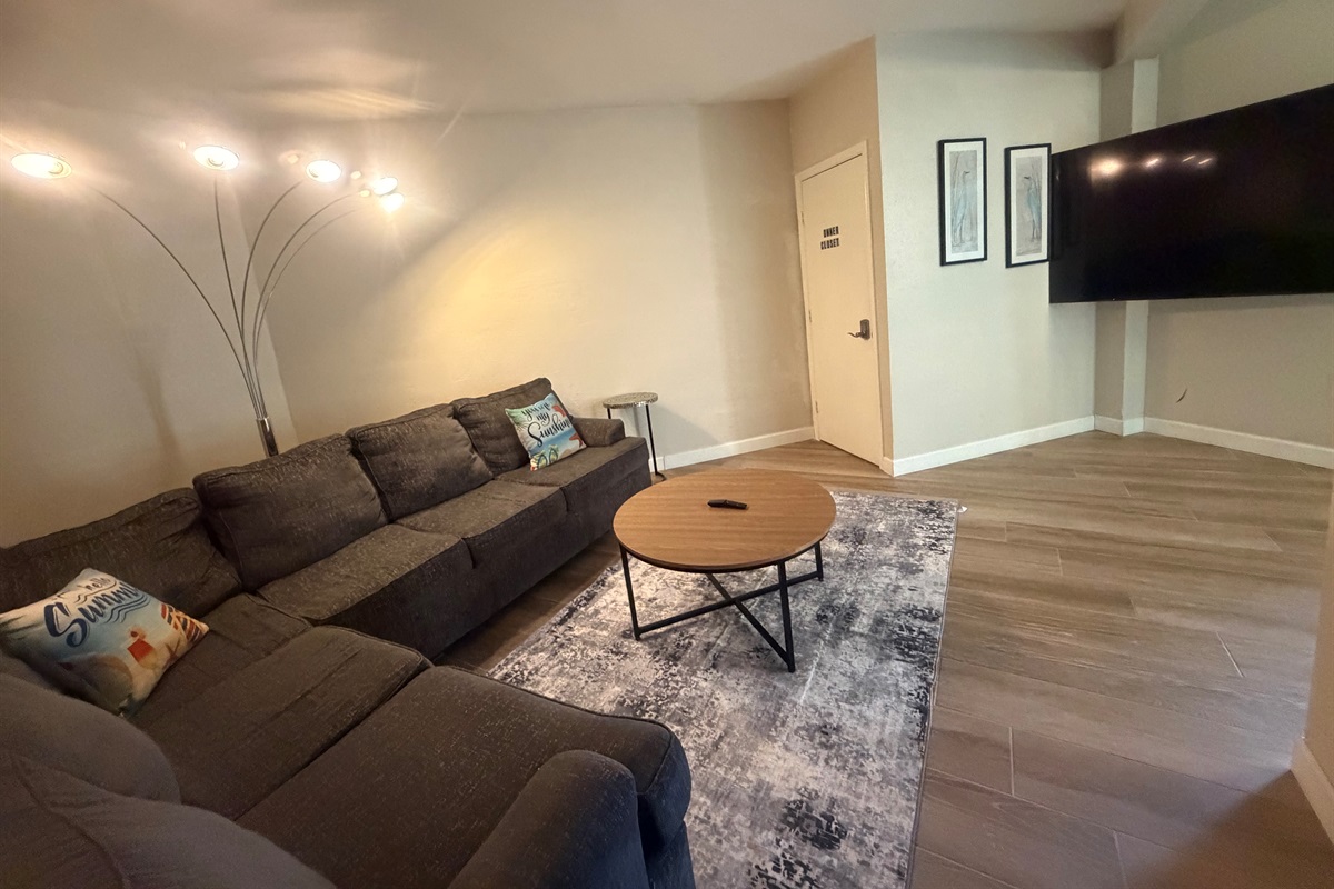 As you enter the house, you will see this sofa at the main level.  This seating area has 70" TV, ideal for a movie night.