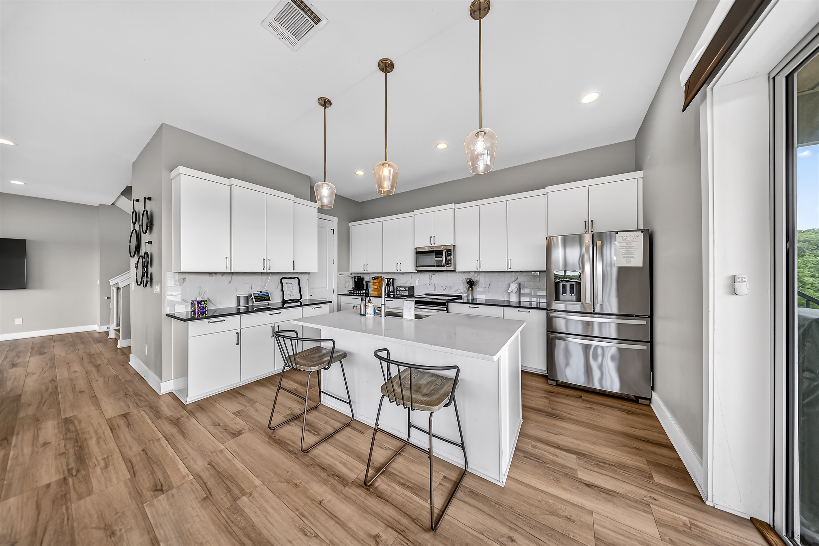 - Modern kitchen with stainless appliances offers bright lakeview charm - Island seating supports cooking chatting and fun vacation moments - Clean layout elevates your lakeside experience with style and ease