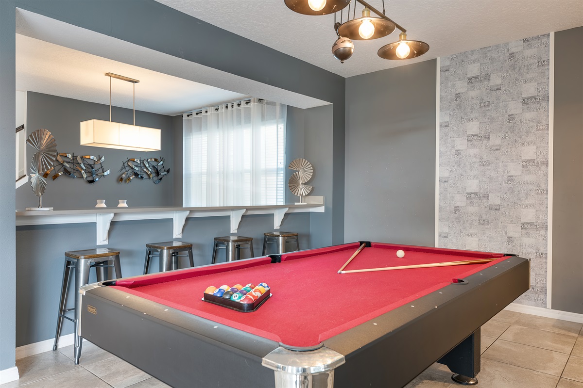 Pool Hall: Play your best shot in style with a vibrant pool table and sleek bar seating!
