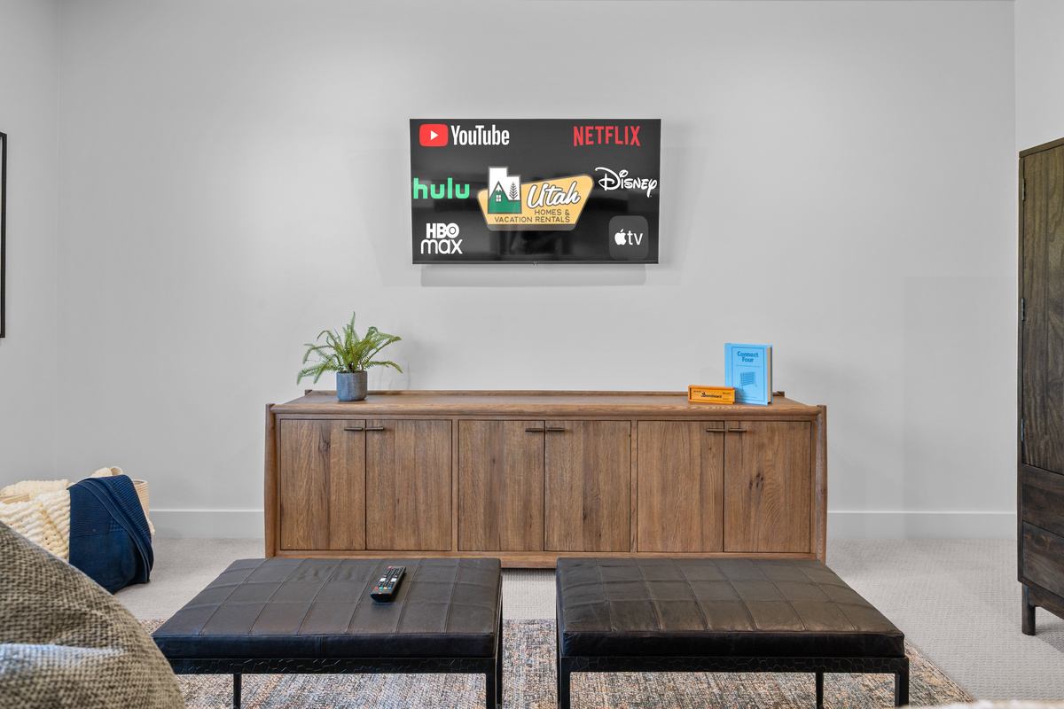 Smart TV and seating area create a fun retreat for movie nights.
