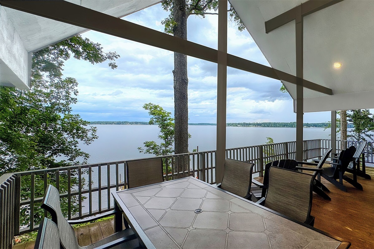 Front deck of home with dining for 6 and additional seating.  Fans, speakers
