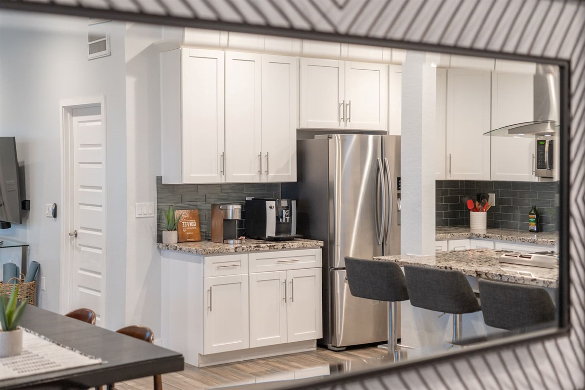 Elegant kitchen equipped with high-end stainless steel appliances, granite countertops, and a modern, stylish design.