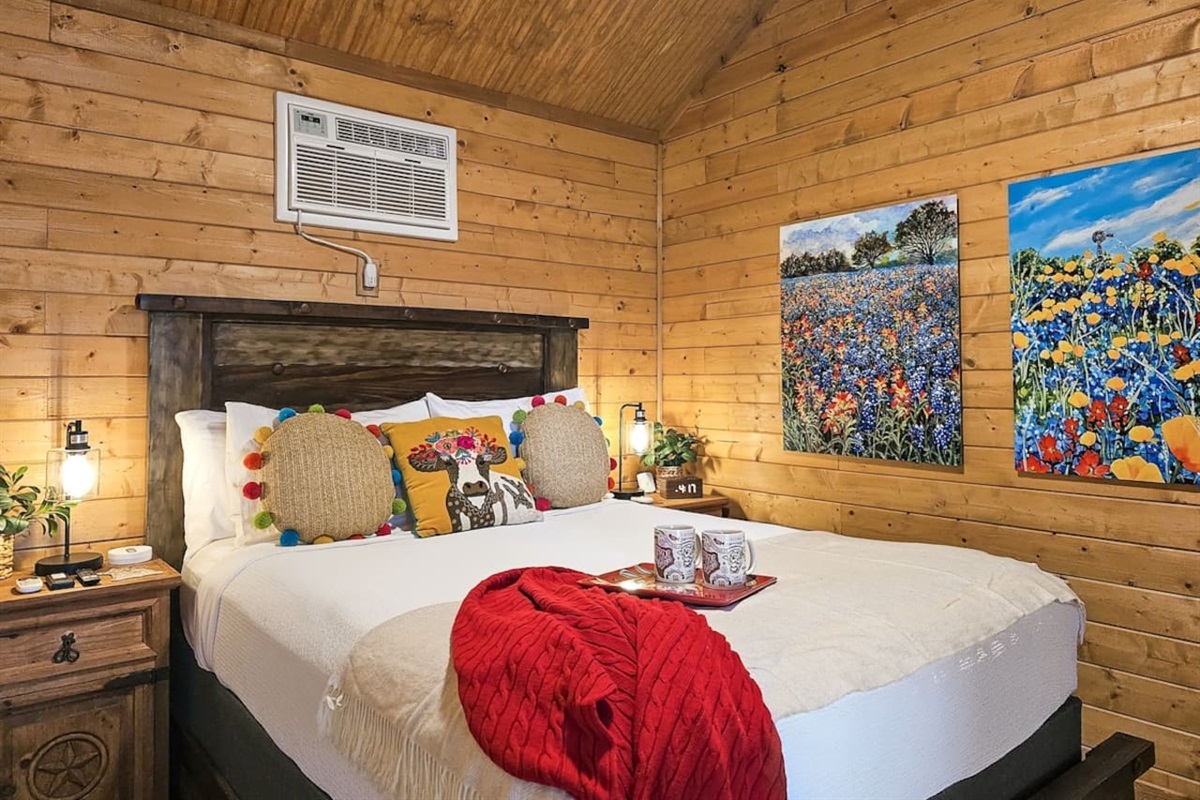  Drift off to sleep in this cozy bedroom, where Texas wildflowers and warm accents create the perfect retreat.